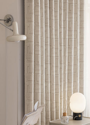 a room with a lamp and a curtain