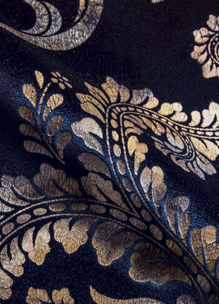 a close up of a blue and gold fabric