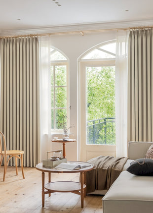 a living room filled with furniture and a large window