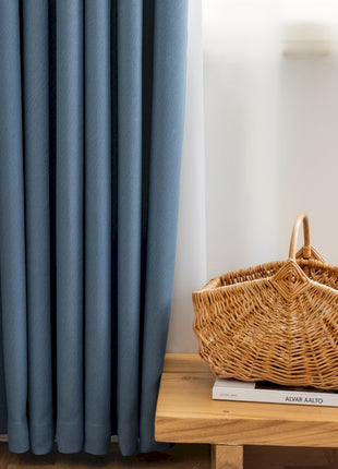 a wicker basket sitting on top of a wooden table