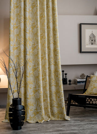 a living room with a chair and a curtain