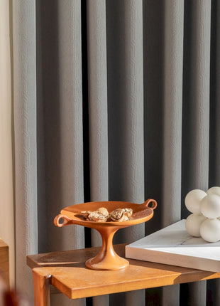 a wooden table topped with a tray of food