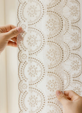 a person is working on a lace curtain