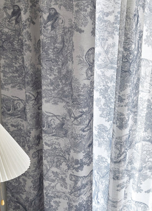 a lamp sitting next to a curtain with a bird on it