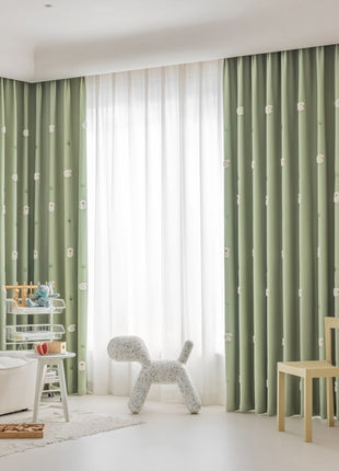 a child's room with green curtains and white furniture