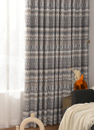 a living room filled with furniture and a window covered in curtains