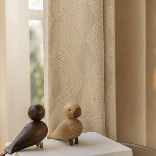 a couple of wooden birds sitting on top of a table