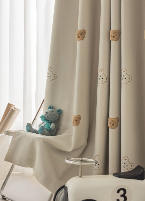 a teddy bear sitting on top of a toy car