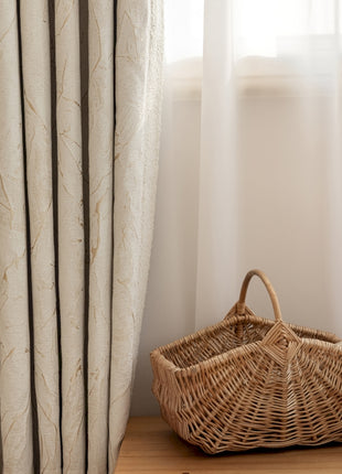 a wicker basket sitting on a table next to a window