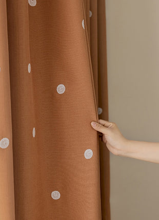 a person is opening the curtain with their hand