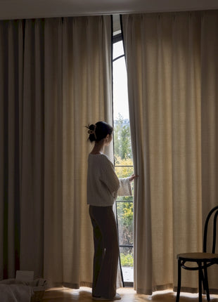 a woman standing in front of a window