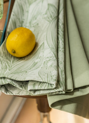 a lemon sitting on top of a table next to a glass