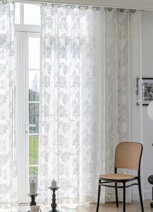 a living room with a chair and a window