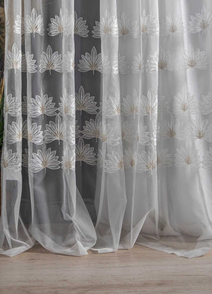 a white curtain with a flower design on it