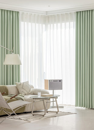 a living room filled with furniture and a large window