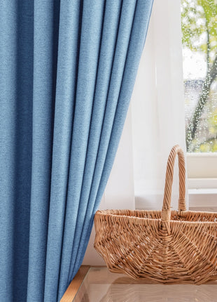 a wicker basket sitting next to a window