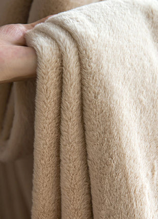 a person's hand is holding a beige towel