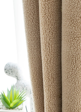 a close up of a cat laying on a bed