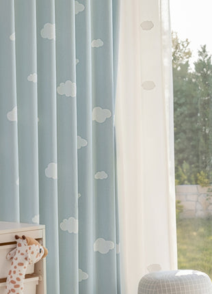 a stuffed giraffe sitting next to a window