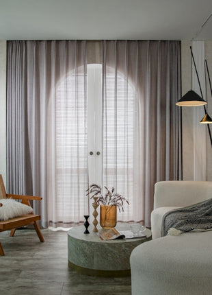 a living room filled with furniture and a large window