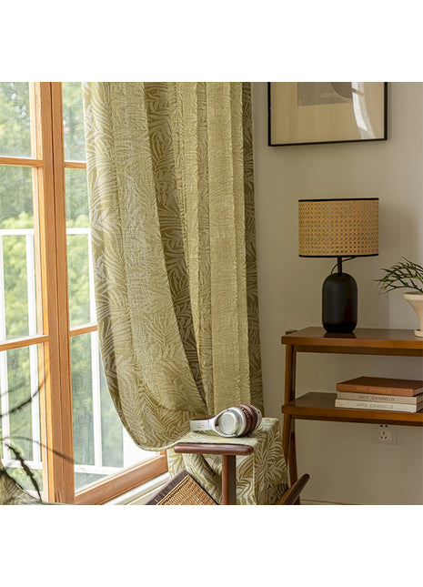 a living room with a chair and a window