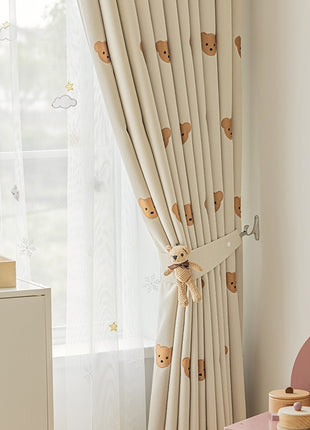 a child's room with a teddy bear curtain