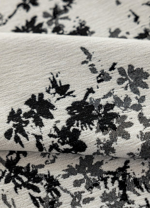 a close up of a black and white flowered fabric