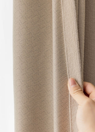 a person is holding a curtain in front of a window