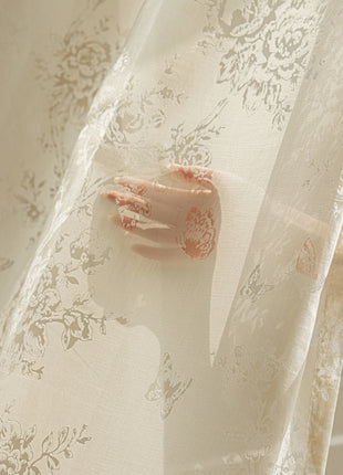 a hand is sticking out of a sheer curtain