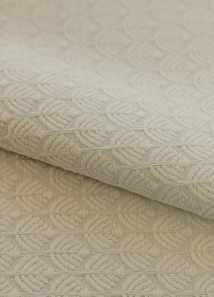 a close up of a white fabric with a pattern