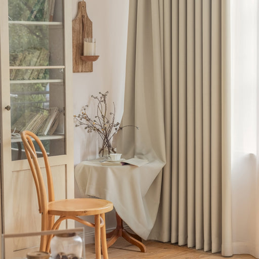 a room with a chair, table and a window