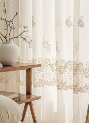 a white vase sitting on top of a wooden table