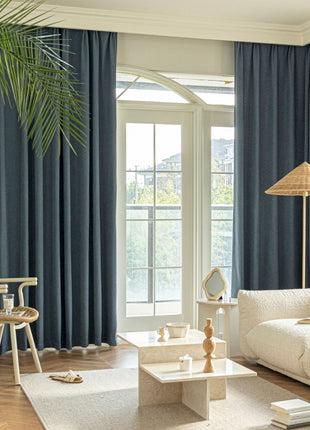 a living room filled with furniture and a large window