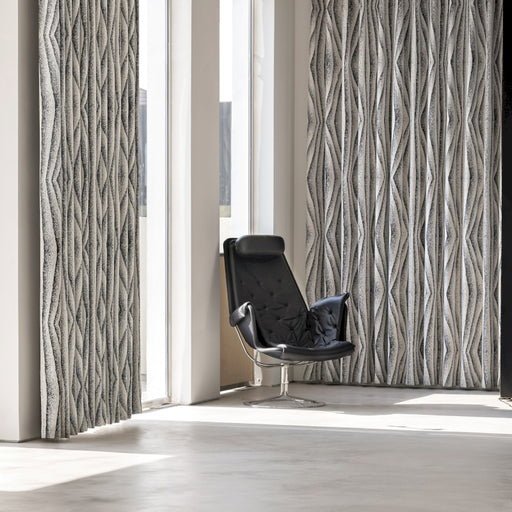 a black chair sitting in front of a window