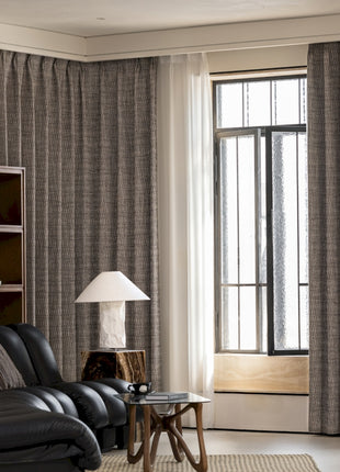 a living room filled with furniture and a large window