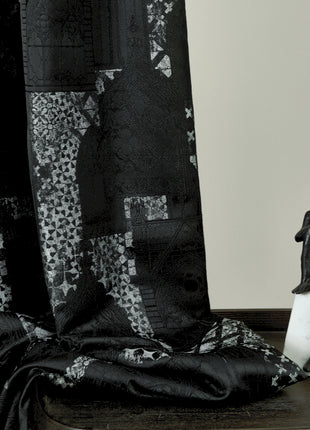 a black and white photo of a figurine on a table