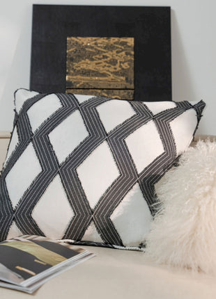 a white couch with a black and white pillow