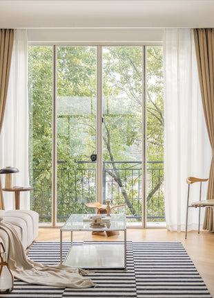 a living room filled with furniture and a large window