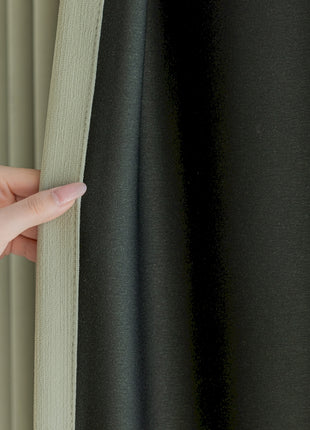 a hand is holding the curtain to the side of a window