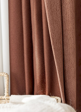 a wicker chair sitting in front of a window