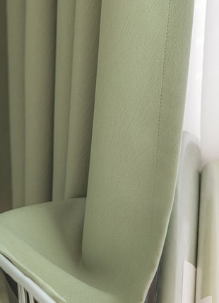 a green chair sitting next to a window