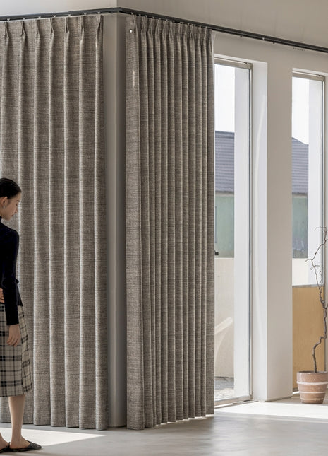 a woman standing in front of a window