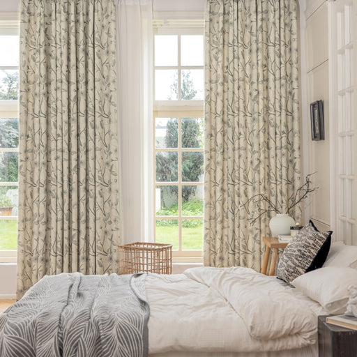 a bedroom with a bed and two windows