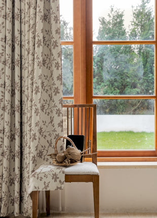 a chair sitting in front of a window next to a window
