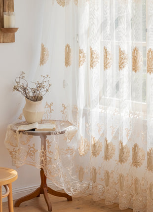 a table with a vase on top of it next to a window